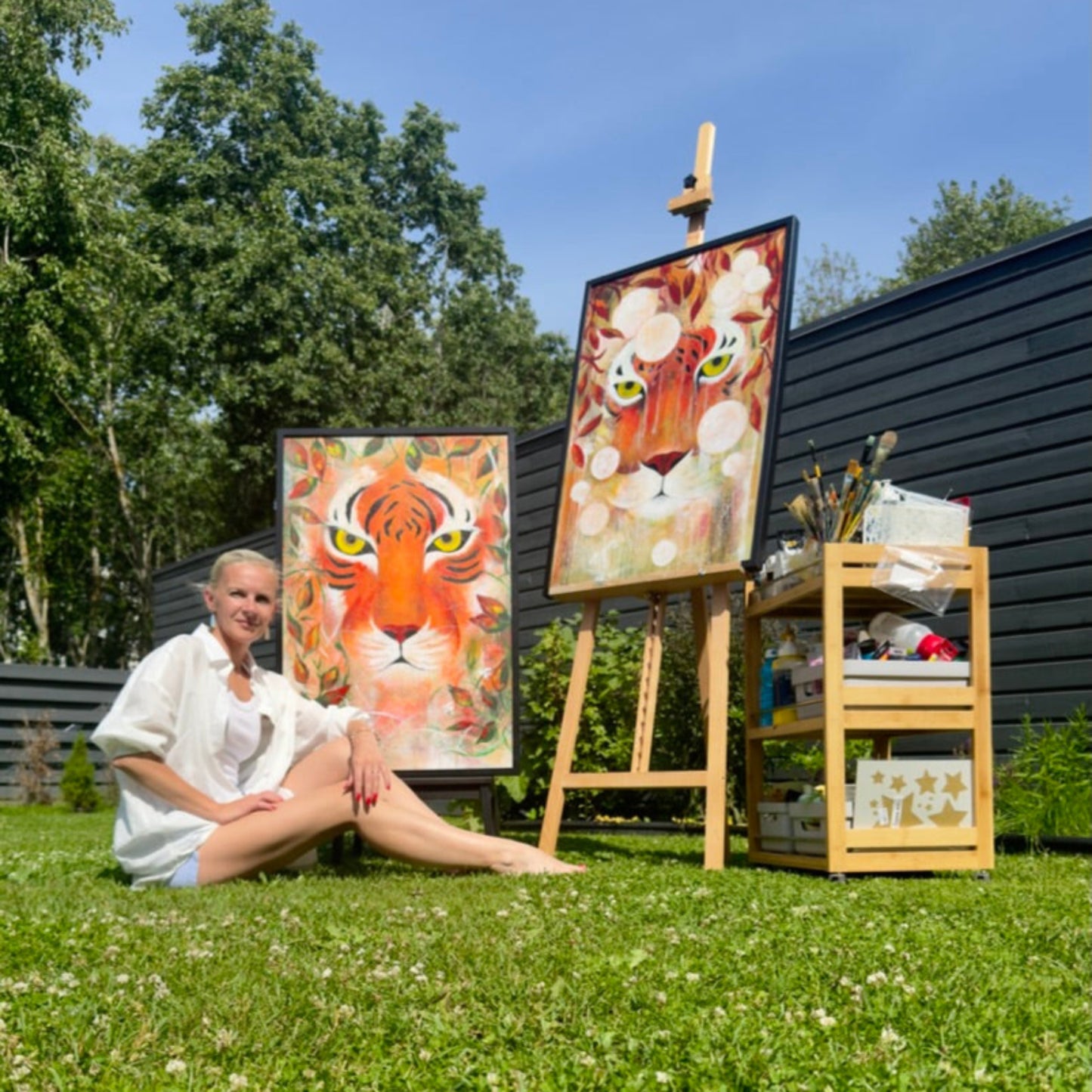 ARtist with her tiger paintings